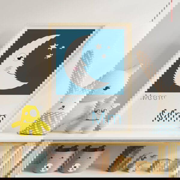 Children's alphabet print featuring a moon resting on shelf in a childs bedroom