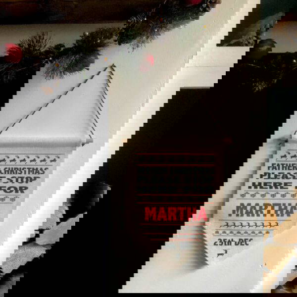 3. Personalised-Santa-Stop-here-sign-pennant-flag-hung-up father Christmas stop here sign hung up by the fireplace personalised with a name