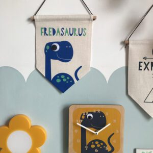 Dinosaur themed gifts hung up on a bedroom wall.