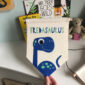 dinosaur wall hanging with personalised name and googly eye