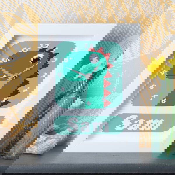 CLD1075-Dinosaur Clock Personalised dinosaur clock on a shelf in a child’s bedroom